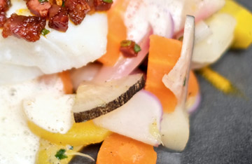 Cod with chorizo and seasonal vegetables
